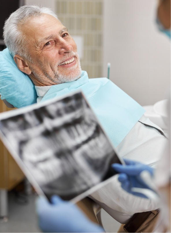 senior-citizen-sitting-in-dental-chair-looking-at-2021-09-03-14-18-42-utc